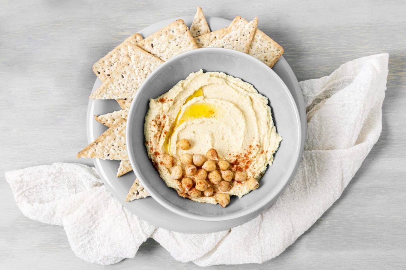 Photo of a plate of hummus illustrates blog "Who Invented Hummus? (And Other Common Questions About Hummus)"