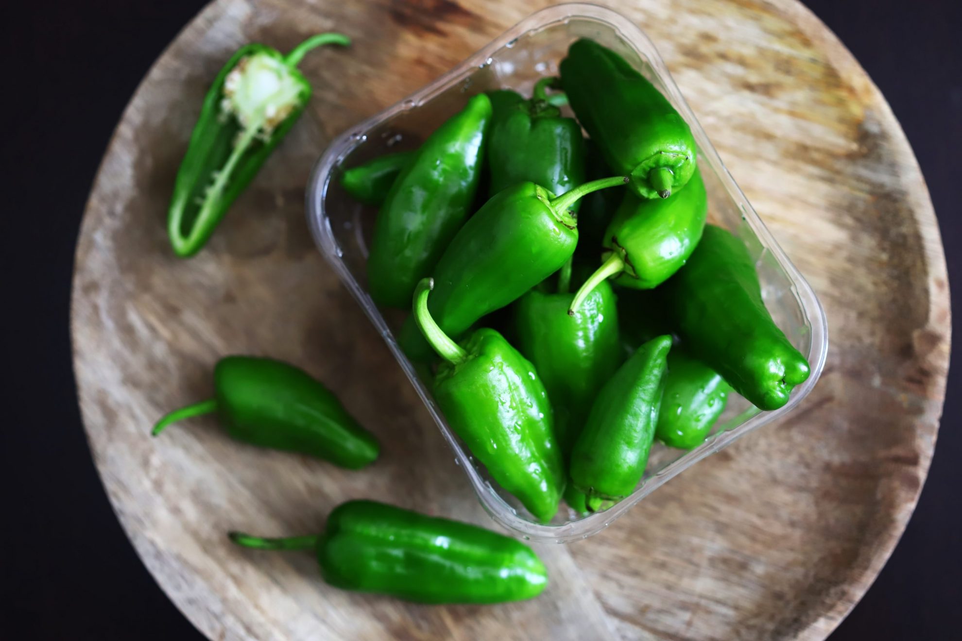 Photo of jalapenos in a container illustrates blog: "Sriracha or Jalapeno: Which One Is Hotter?"
