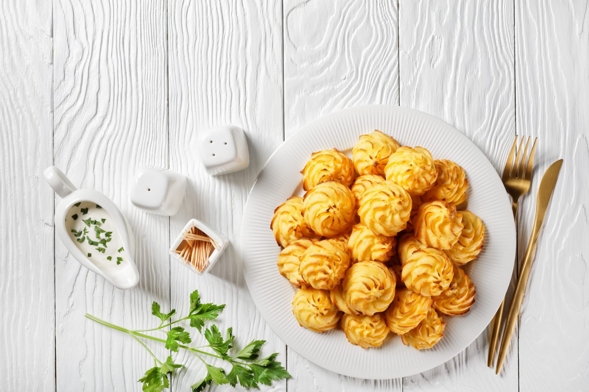 Photo of a plate of duchess potatoes.