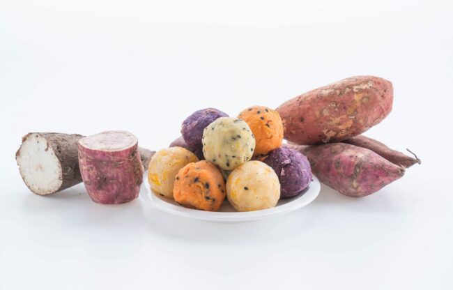 Plate of cut and peeled potatoes and sweet potatoes.