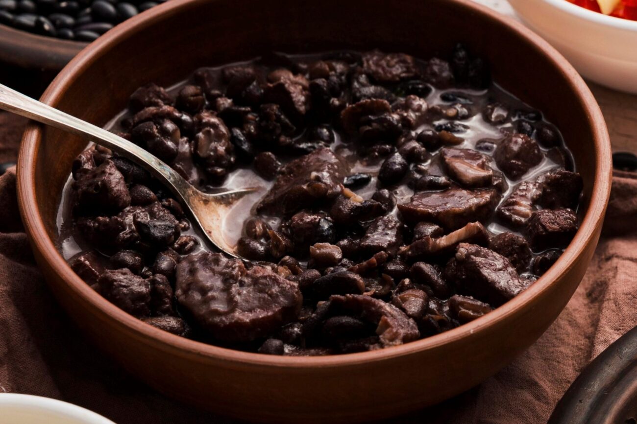 Bowl of black beans with meat illustrates blog "Are Black Beans a Good Protein Source?"