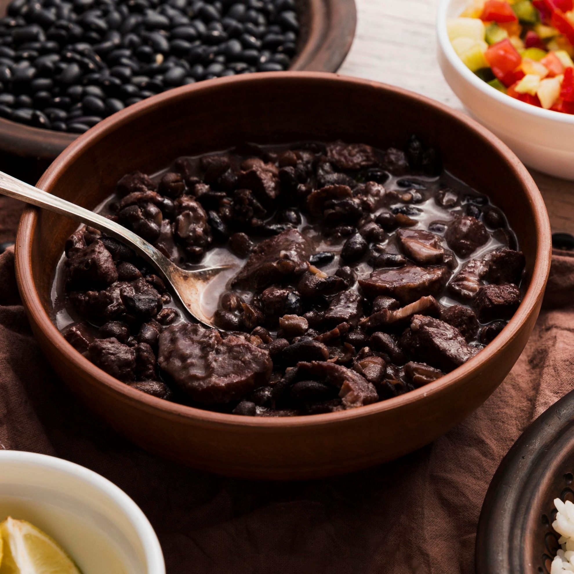 Bowl of black beans with meat illustrates blog "Are Black Beans a Good Protein Source?"
