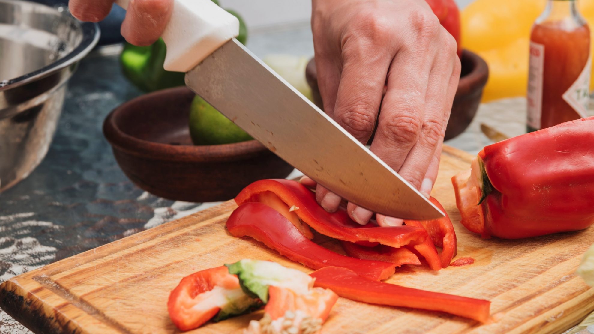 KnifeChef Chef cutting peppers illustrates blog "5 Essential Cooking Tools Everyone Needs"