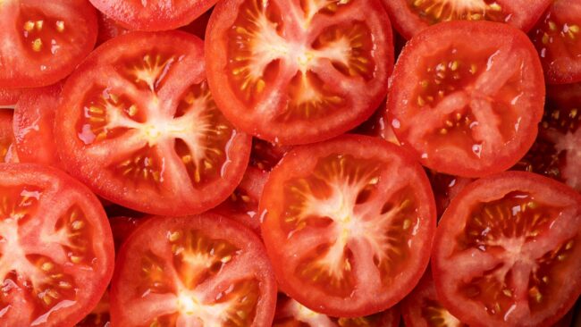Photo of sliced tomatoes illustrates blog "Tomato vs Tomatillo: What Is the Difference?"