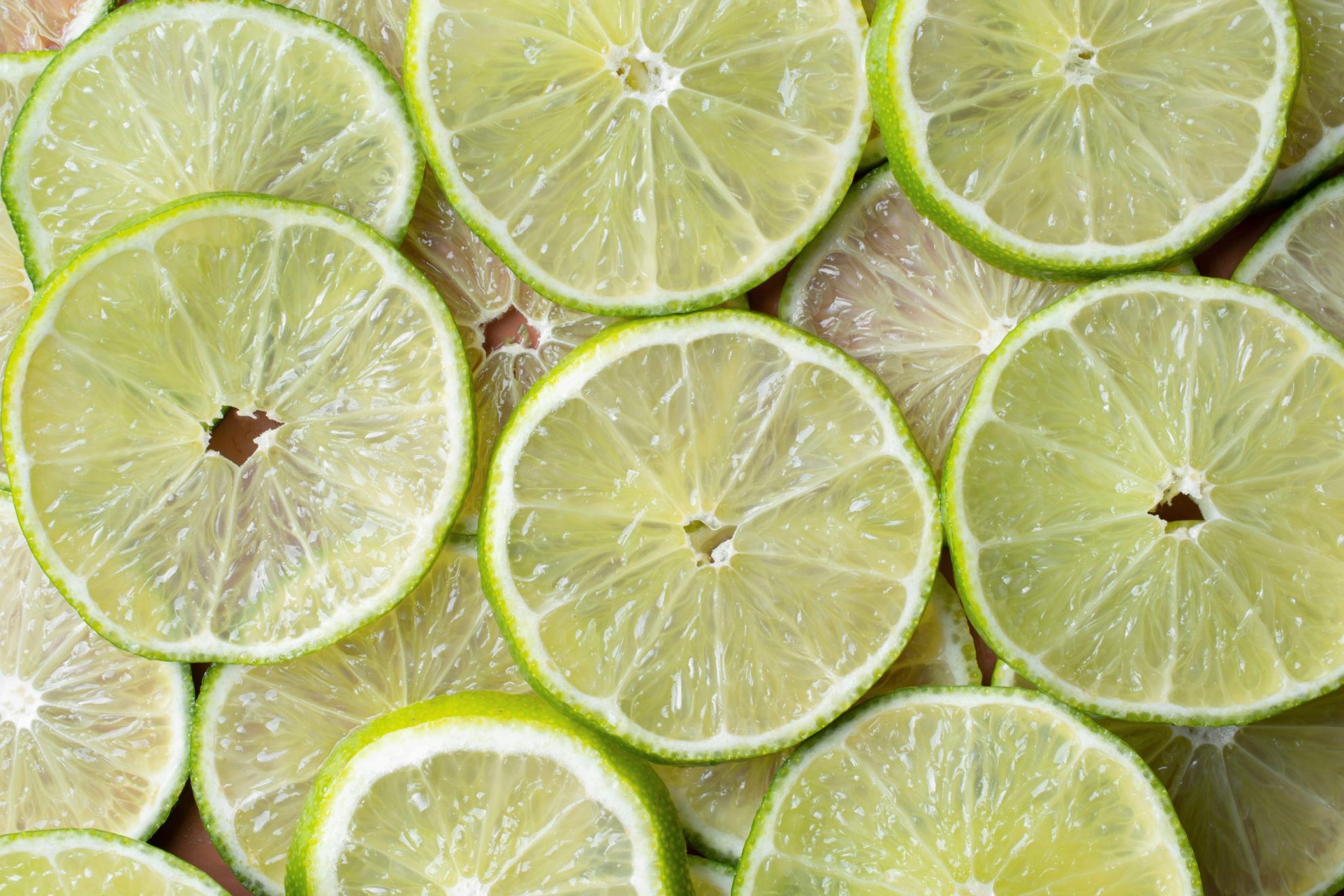 Limes cut in slices illustrate blog "Lemon vs Lime: What Is the Difference?"