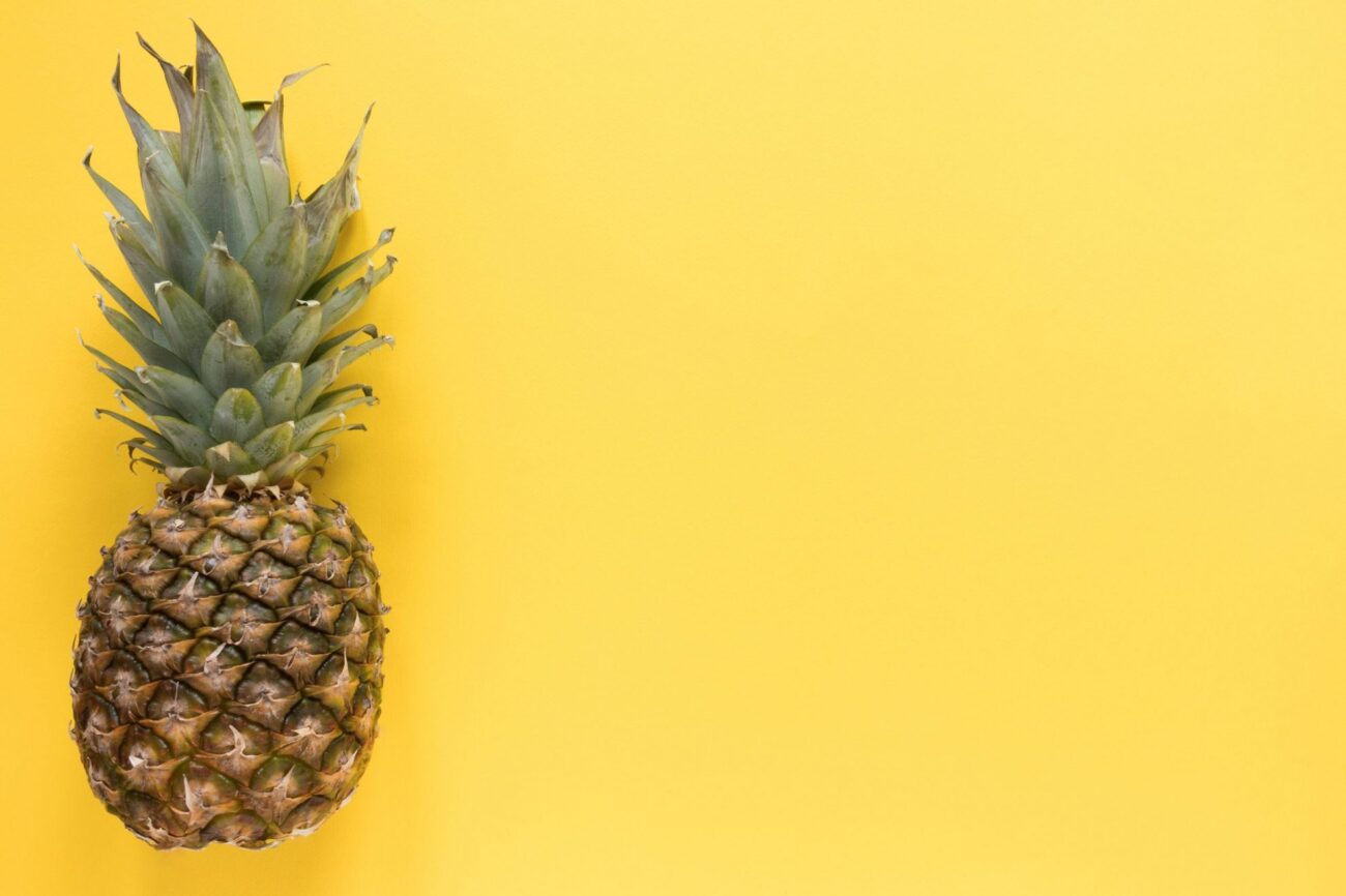 Pineapple on yellow background illustrates blog "Why Does Pineapple Taste Fizzy?"