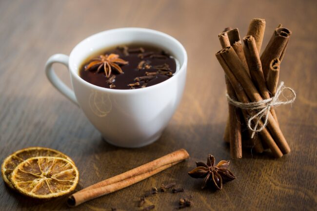 cinnamon-FP Cinnamon sticks by white cup illustrate blog "Does Cinnamon Come From a Tree?"