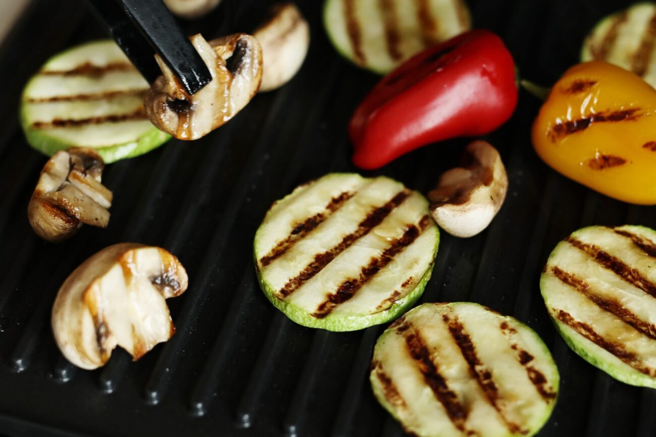 Closeup of person grilling vegeables.