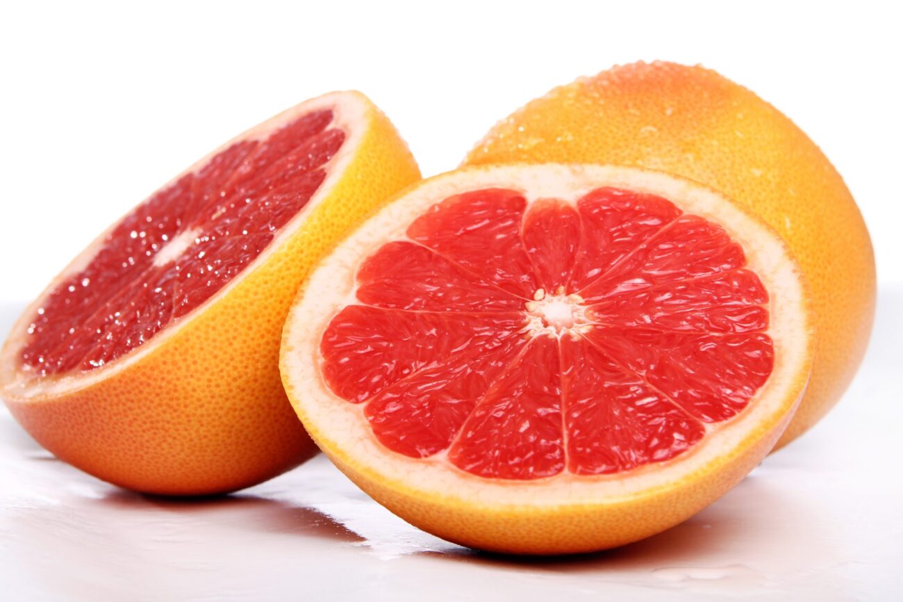 grapefruit-racool_studio Whole grapefruit and grapefruit cut in half illustrate blog "Is Grapefruit Bitter?"