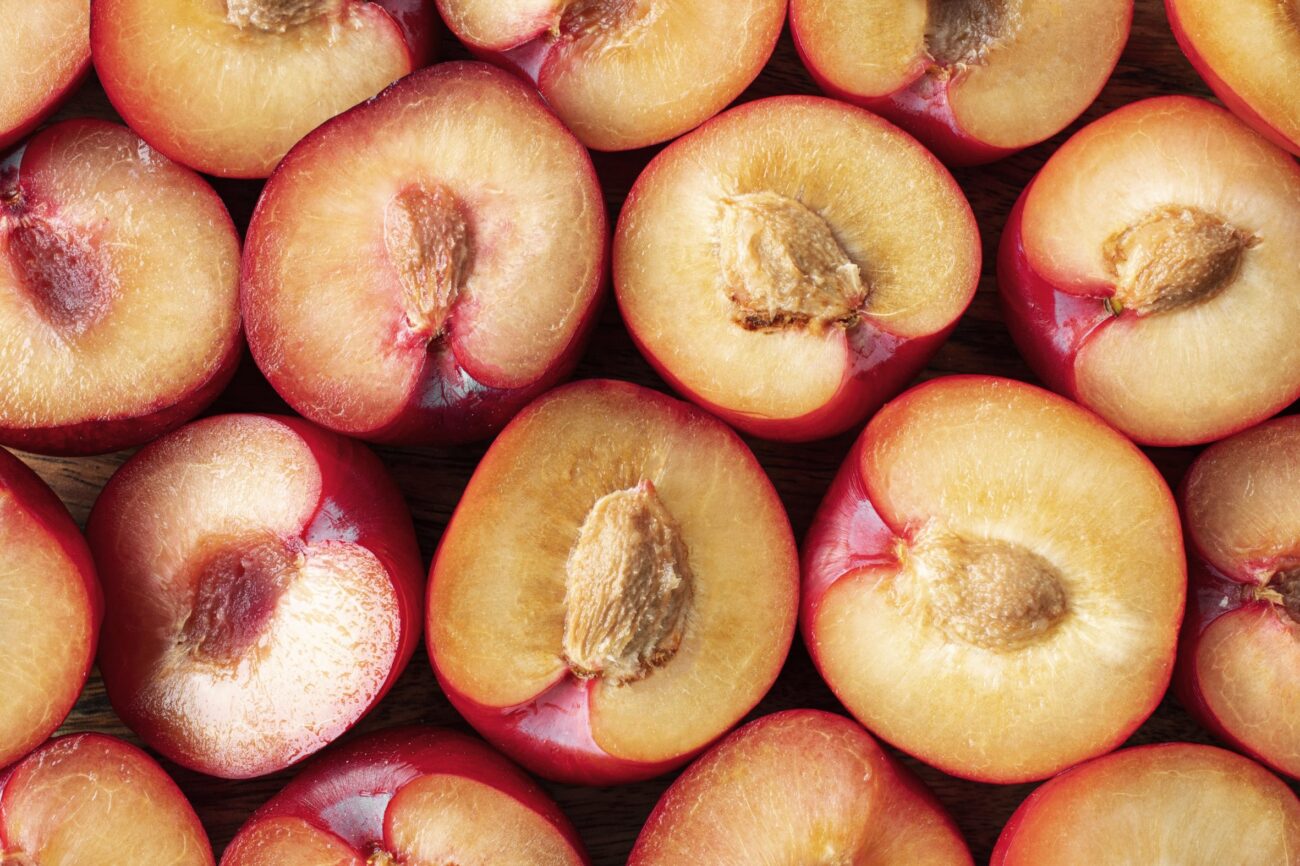Peaches cut in half illustrate blog "Are Almonds Part of the Peach Family?"