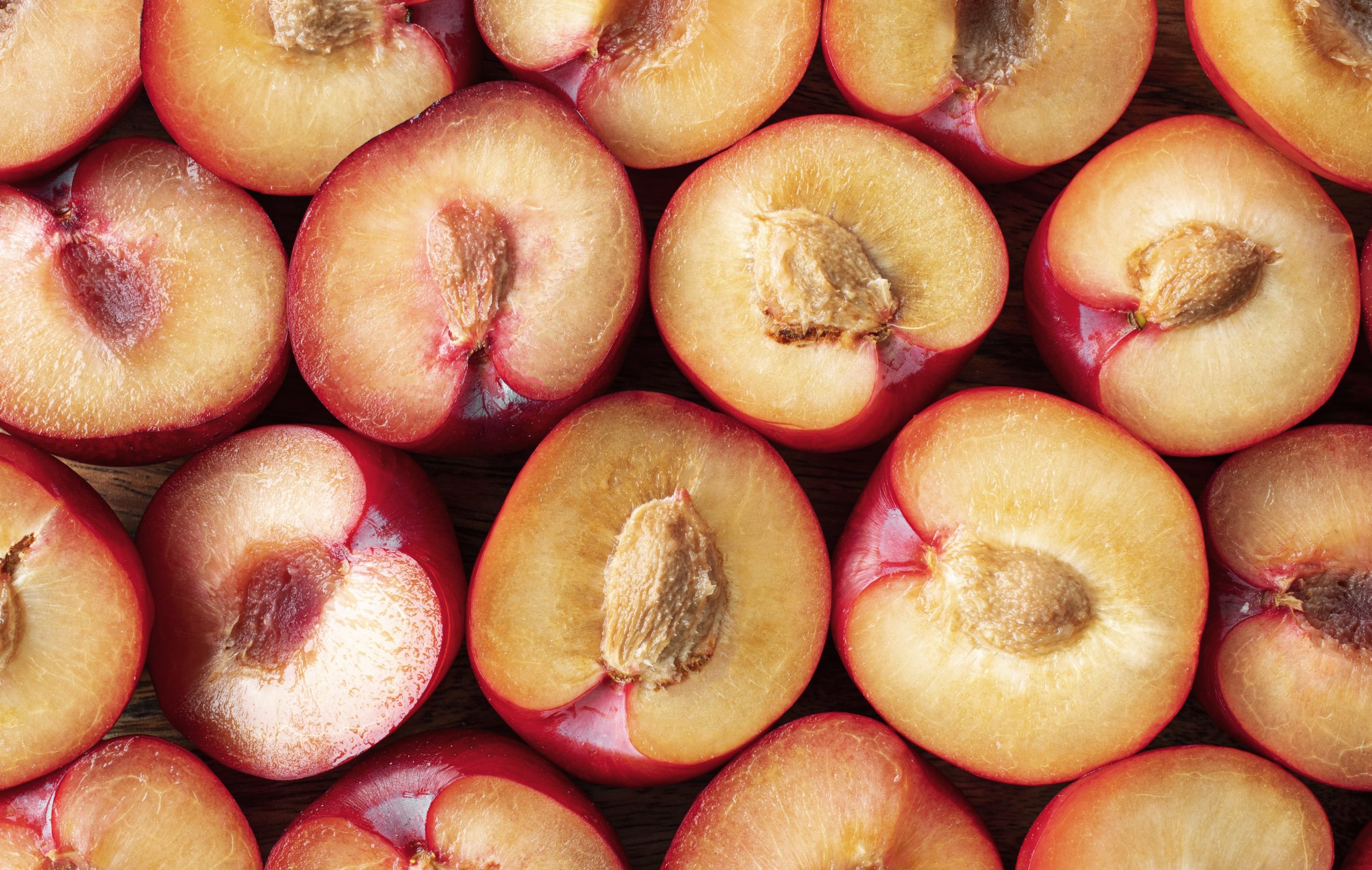 Closeup of halved peaches.