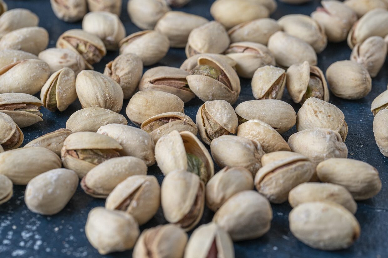 Closeup of pistachios illustrates blog "Are Pistachios Vegan?"