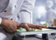 hef preparing allergen-friendly corporate catering dishes in a professional kitchen