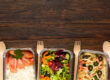 Chef-prepared meals displayed beside packaged office food in a workplace setting